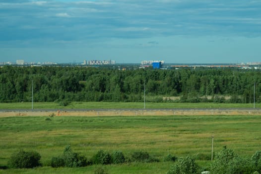 Urban cityscape panoramic view. horizon line with buildings. nature landscape with town and forest. blue sky. city into a distance
