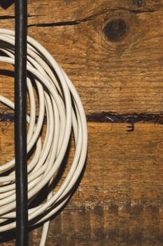 White and black cable on a wooden background. connection wire close up