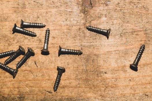 Screws on a wooden background.working tools. copy space