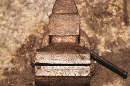 Old bench vise on a metal workbench. work tool