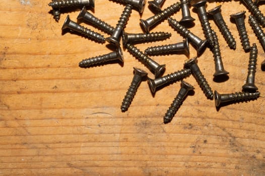 Screws on a wooden background.working tools. copy space