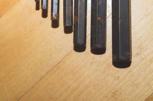 Allen wrenches set. old hexagonal wrenches on a wooden background