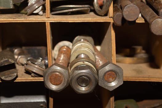 Old screws in a box. a lot of various screws. pile of fasteners in the box close up. carpentry workshop. work tool