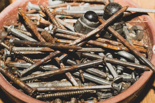 Old screws in a box. a lot of various screws. pile of fasteners in the box close up. carpentry workshop. work tool