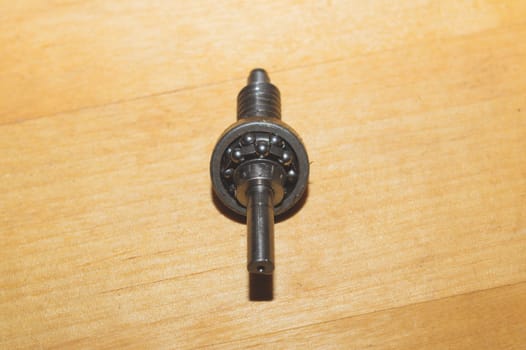 Metal shaft and bearing on a wooden table