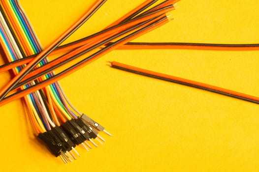 Colorful wires isolated on yellow background. connection wire for electrical schemes and devices. copy space
