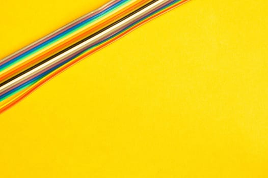 Colorful wires isolated on yellow background. connection wire for electrical schemes and devices. copy space