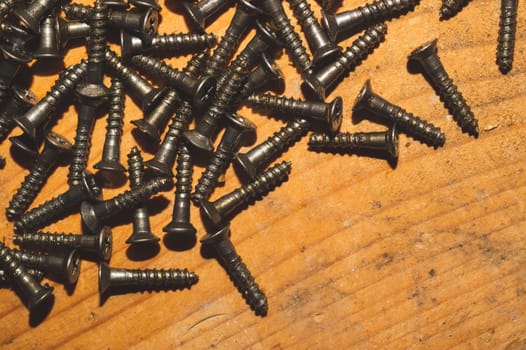 Screws on a wooden background.working tools. copy space