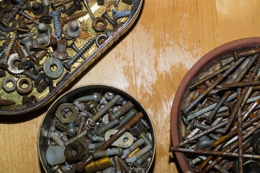 Old screws in a box. a lot of various screws. pile of fasteners in the box close up. carpentry workshop. work tool