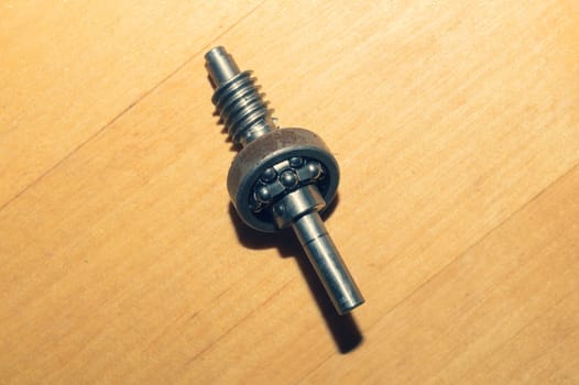 Metal shaft and bearing on a wooden table