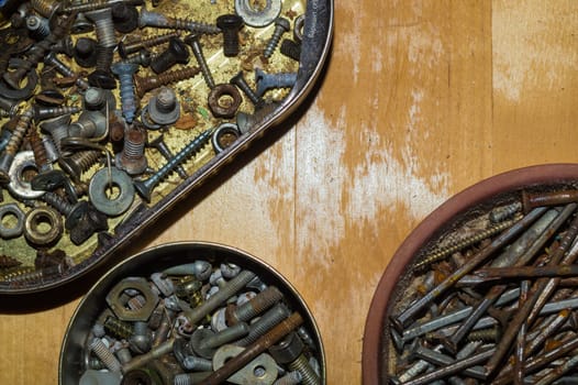 Old screws in a box. a lot of various screws. pile of fasteners in the box close up. carpentry workshop. work tool