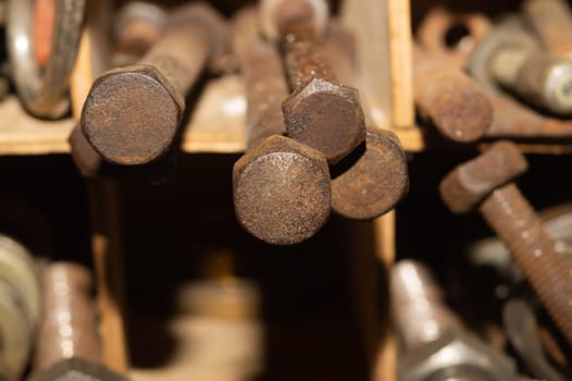 Old screws in a box. a lot of various screws. pile of fasteners in the box close up. carpentry workshop. work tool