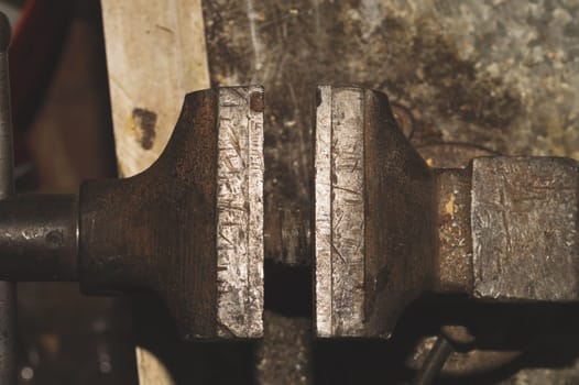 Old bench vise on a metal workbench. work tool
