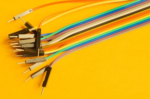 Colorful wires isolated on yellow background. connection wire for electrical schemes and devices. copy space