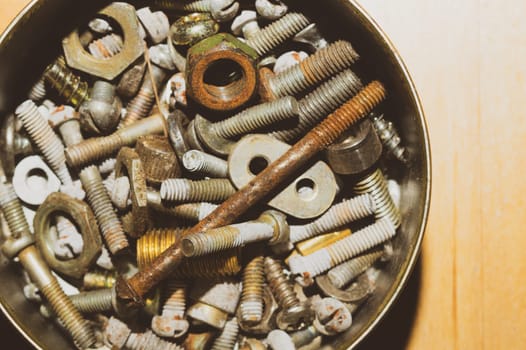 Old screws in a box. a lot of various screws. pile of fasteners in the box close up. carpentry workshop. work tool