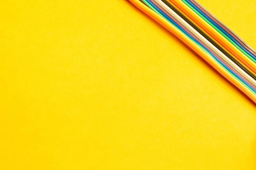 Colorful wires isolated on yellow background. connection wire for electrical schemes and devices. copy space
