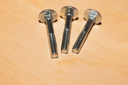 Screws on a wooden background.working tools. copy space
