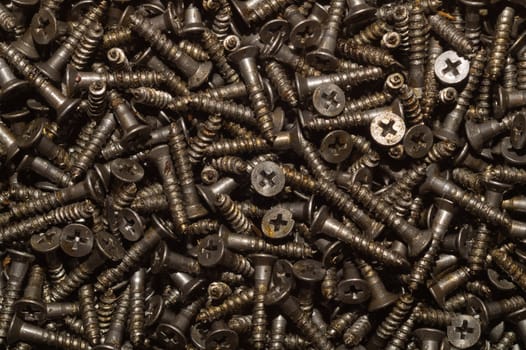 Screws background. heap of tapping screws. work tool. pile of fasteners