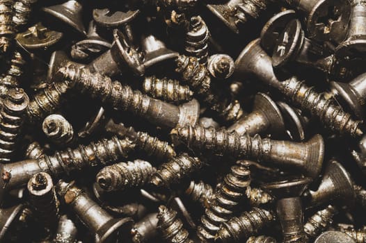 Screws background. heap of tapping screws. work tool. pile of fasteners
