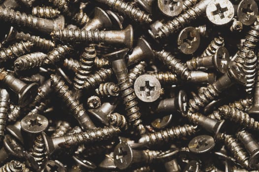 Screws background. heap of tapping screws. work tool. pile of fasteners