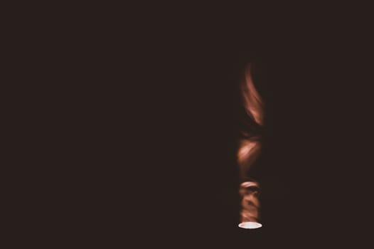 Colored smoke on black backdrop. brown fog abstract background