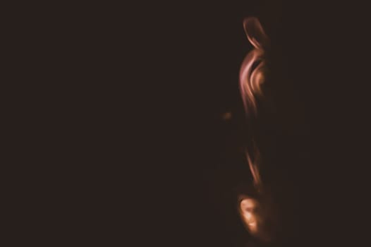 Colored smoke on black backdrop. brown fog abstract background
