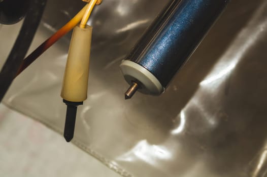 Old electrical probes hanging in the workshop. multimeter probe