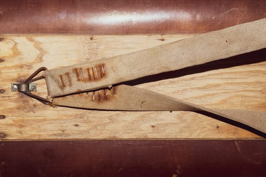 Wooden surface with nailed straps. side of wooden box with belts for carrying