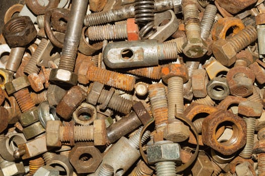 Rusty bolts and nuts of different sizes. scrap metal. industrial background