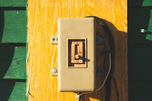 Vintage electrical switch panel. retro power toggle on the wooden wall