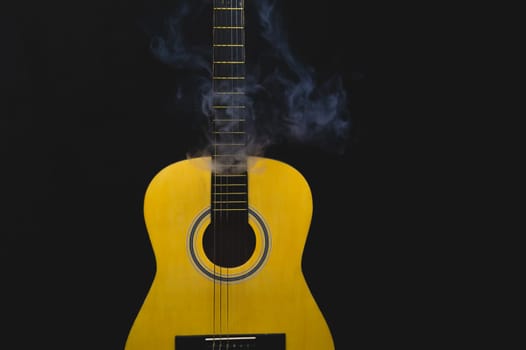 Guitar in smoke close up. musical instrument. strings on the guitar neck