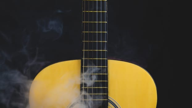 Guitar in smoke close up. musical instrument. strings on the guitar neck