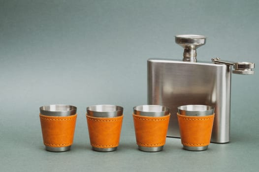 Metallic flask. shot glasses with funnel. travel shot glass for alcohol with leather casing over the stainless steel. personal accessory set. copy space