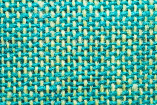 Fabric macro texture. knitted textile close up. woven background. woolen material. weaving green and yellow threads