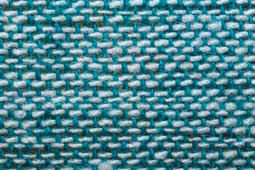 Fabric macro texture. knitted textile close up. woven background. woolen material. weaving blue and white threads