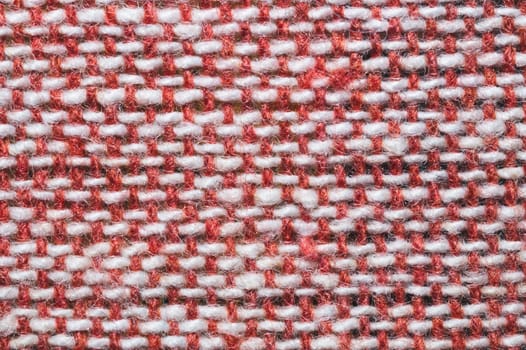 Fabric macro texture. knitted textile close up. woven background. woolen material. weaving of red and white threads