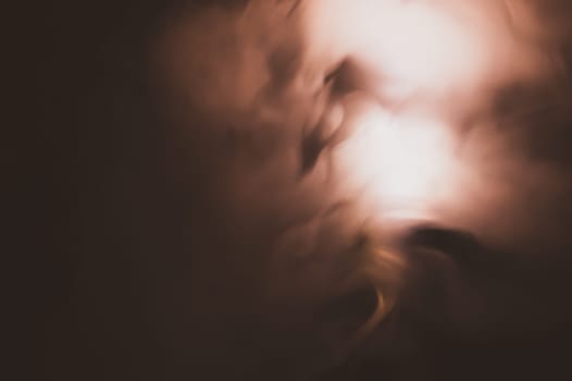 Colored smoke on black backdrop. brown fog abstract background