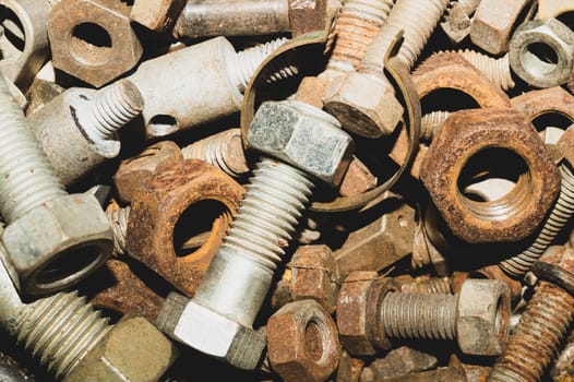 Rusty bolts and nuts of different sizes. scrap metal. industrial background