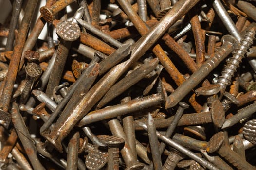 Pile of fasteners and screws close up. scrap metal. different metal parts. industrial background