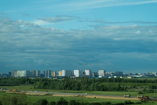 Urban cityscape panoramic view. horizon line with buildings. nature landscape with town and forest. blue sky. city into a distance