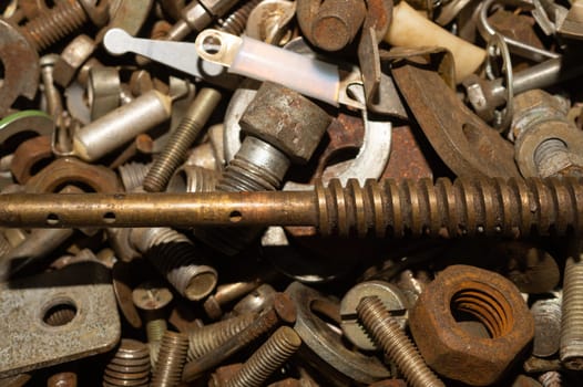 Pile of fasteners and screws close up. scrap metal. different metal parts