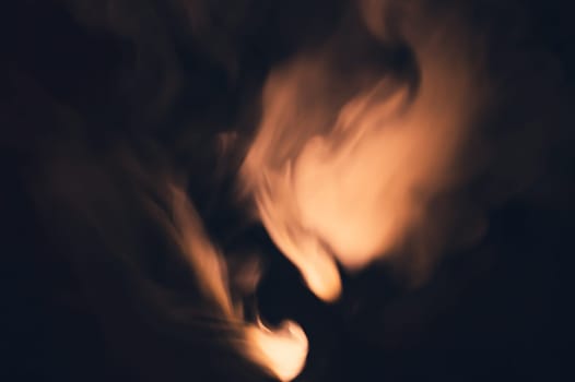Colored smoke on black backdrop. brown fog abstract background