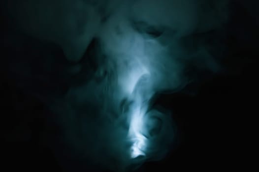Turquoise smoke on black backdrop. color fog abstract background