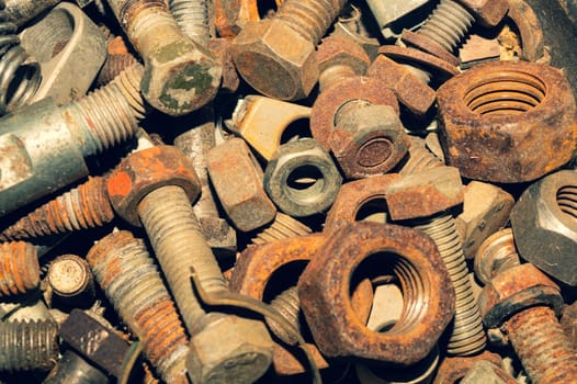 Rusty bolts and nuts of different sizes. scrap metal. industrial background