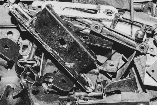 Pile of fasteners and screws close up. scrap metal. different metal parts