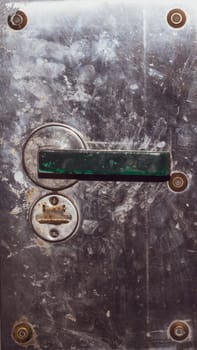 Rusty door handle and keyhole on the metal door. old steel surface. iron surface with doorknob. grunge texture. industrial background