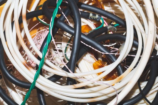 Old hoses and wires close up. twisted hosepipe. gardening equipment
