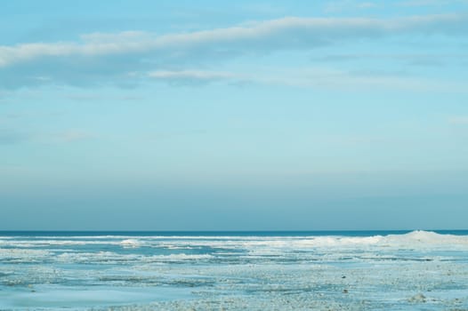 Blue frozen lake with the sky. winter landscape. nature background with a horizon line