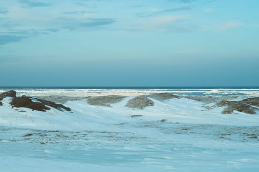 Blue frozen lake with the sky. winter landscape. nature background with a horizon line