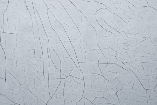 Cracked paint on a wooden surface. grunge texture with peeling paint on wood